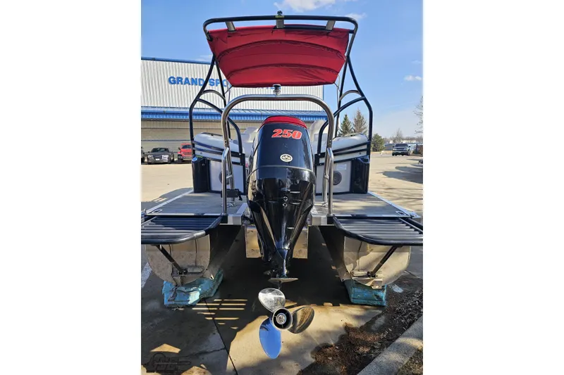 Slide: The Image of 2019 JC Tritoon Neptoon 25 Sport SL with powerful outboard motor, parked outdoors. - 38