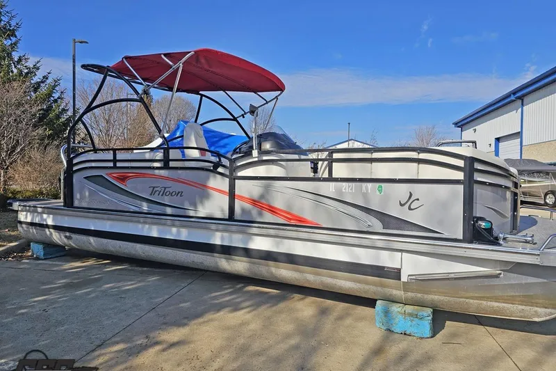 Slide: The Image of 2019 JC Tritoon Neptoon 25 Sport SL pontoon boat with red canopy, parked outdoors. - 4