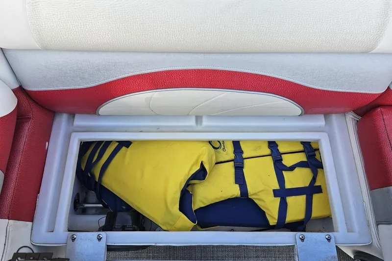 Slide: The Image of Storage compartment in 2019 JC Tritoon Neptoon 25 Sport SL with yellow life jacket. - 75