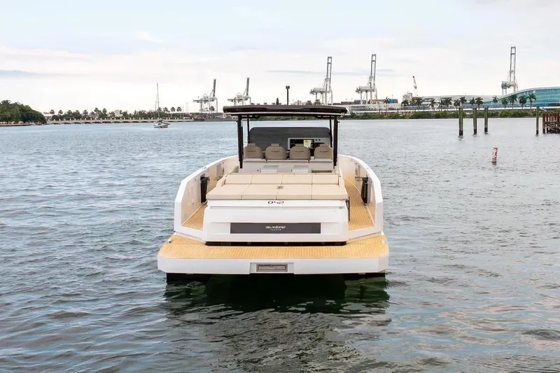 Slide: The Image of De Antonio Yachts D42 2026 on water with harbor in background. - 4