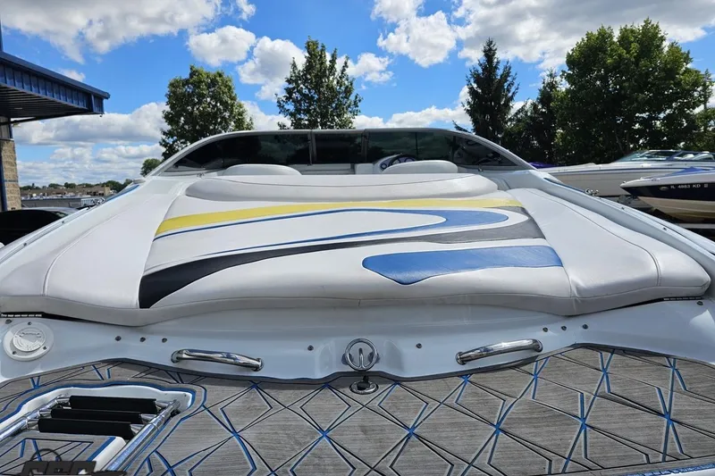 Slide: The Image of 2005 Baja 275 boat with colorful upholstery, docked under a blue sky. - 32