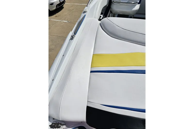 Slide: The Image of 2005 Baja 275 boat interior with white, yellow, and blue upholstery details. - 40