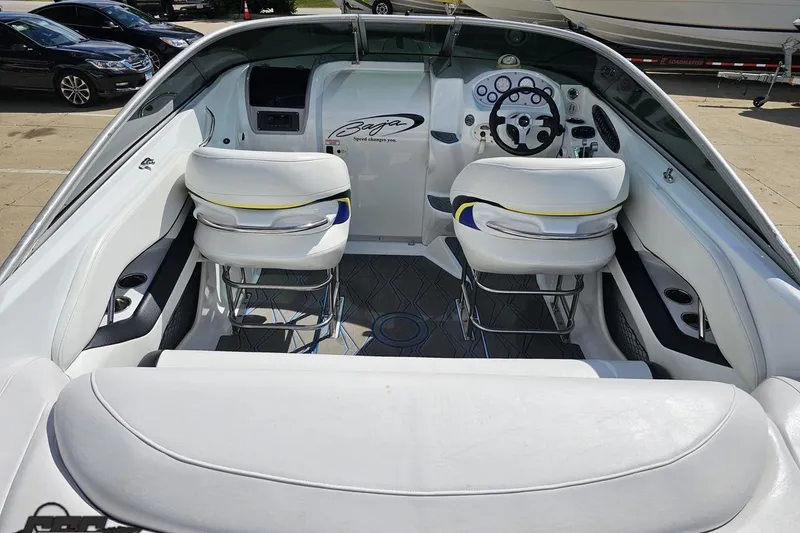 Slide: The Image of 2005 Baja 275 boat interior with white seating and modern dashboard design. - 41