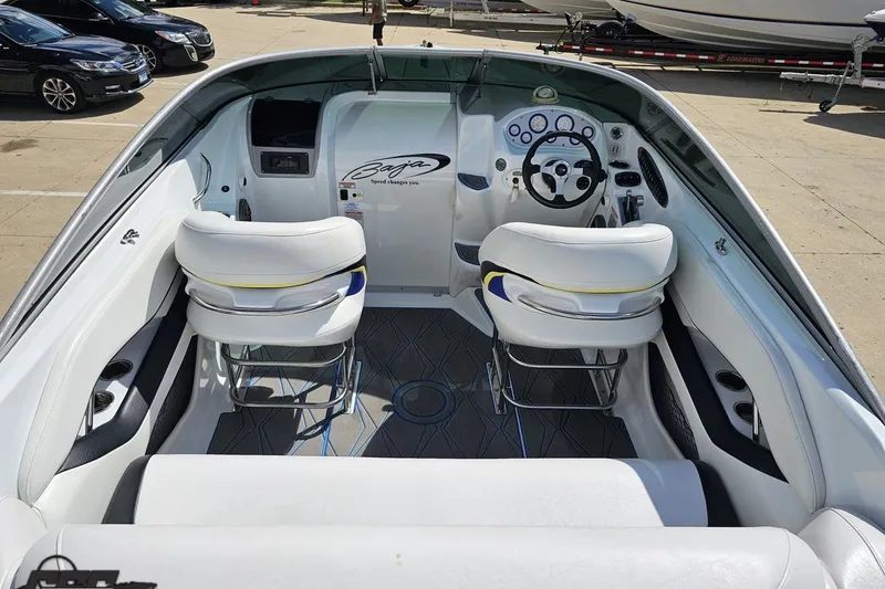 Slide: The Image of 2005 Baja 275 boat interior with white seating and modern dashboard. - 42
