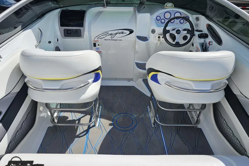 Slide: The Image of 2005 Baja 275 boat interior with white seats and modern dashboard design. - 44