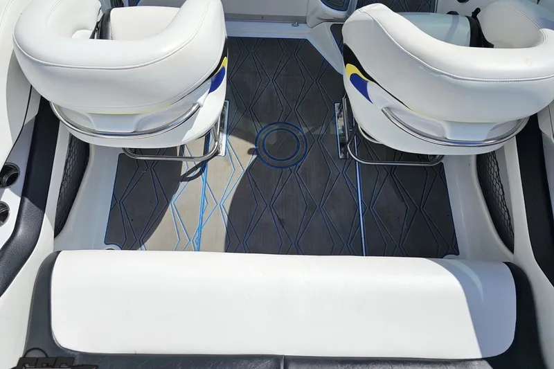 Slide: The Image of Interior of a 2005 Baja 275 boat with white seating and patterned flooring. - 45