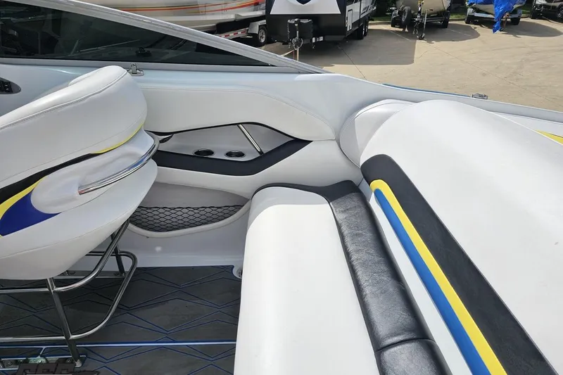 Slide: The Image of Interior of a 2005 Baja 275 boat with white, blue, and yellow seating. - 48
