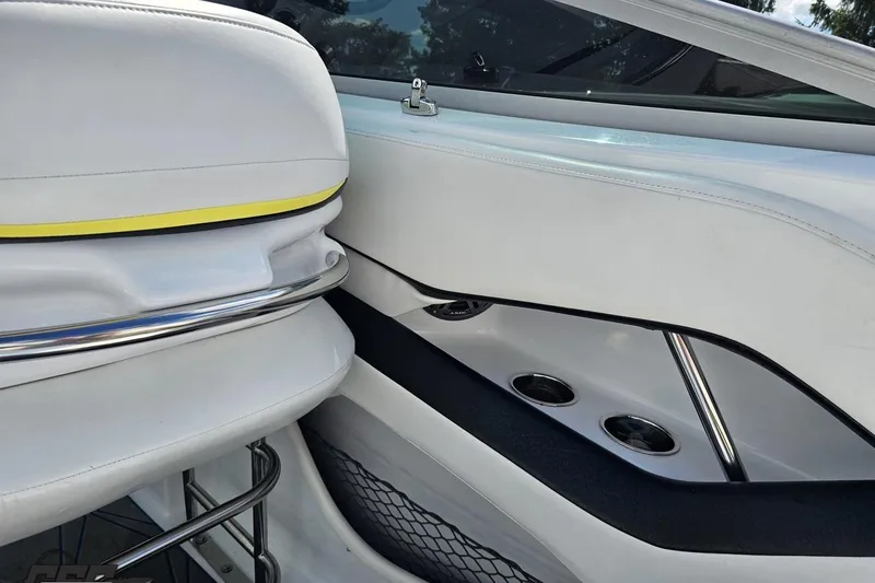 Slide: The Image of Interior of a 2005 Baja 275 boat with white seating and cup holders. - 49