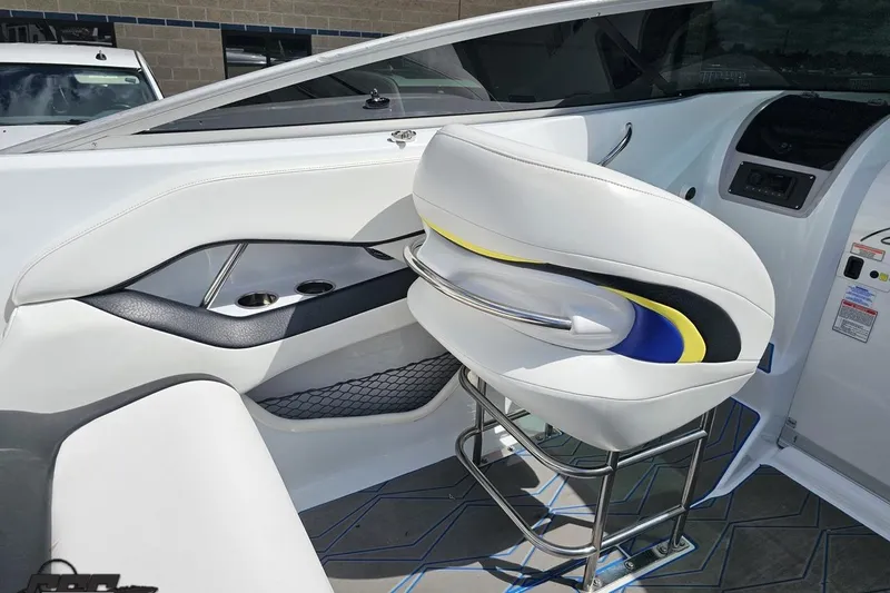 Slide: The Image of Interior of a 2005 Baja 275 boat featuring sleek white seating and modern design elements. - 57