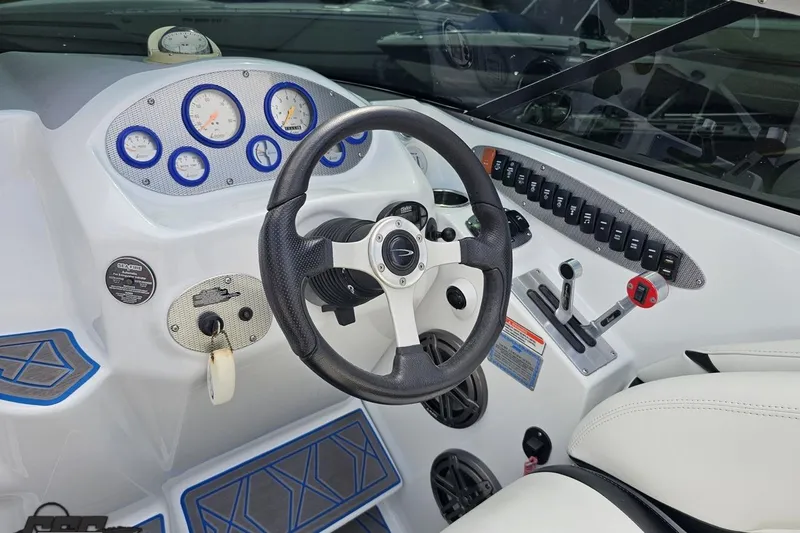 Slide: The Image of 2005 Baja 275 boat dashboard with steering wheel and control panel. - 65