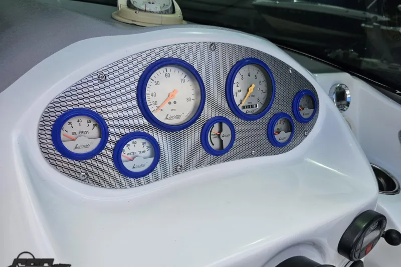 Slide: The Image of Dashboard of a 2005 Baja 275 boat with Livorsi gauges and blue accents. - 67