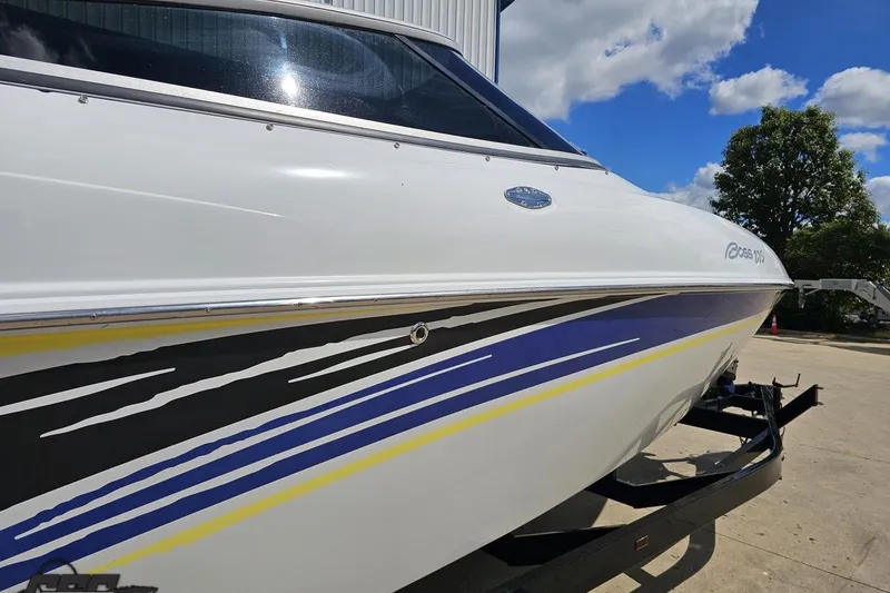 Slide: The Image of 2005 Baja 275 boat with sleek design and vibrant stripes on a sunny day. - 7