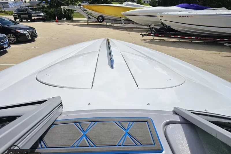 Slide: The Image of 2005 Baja 275 boat deck view in a parking lot with other boats. - 70
