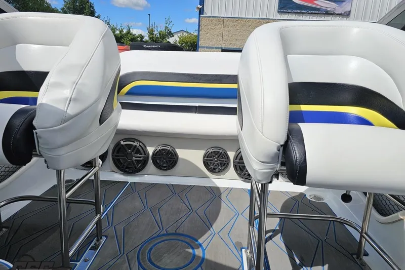 Slide: The Image of 2005 Baja 275 boat interior with white seats, colorful accents, and speaker system. - 83