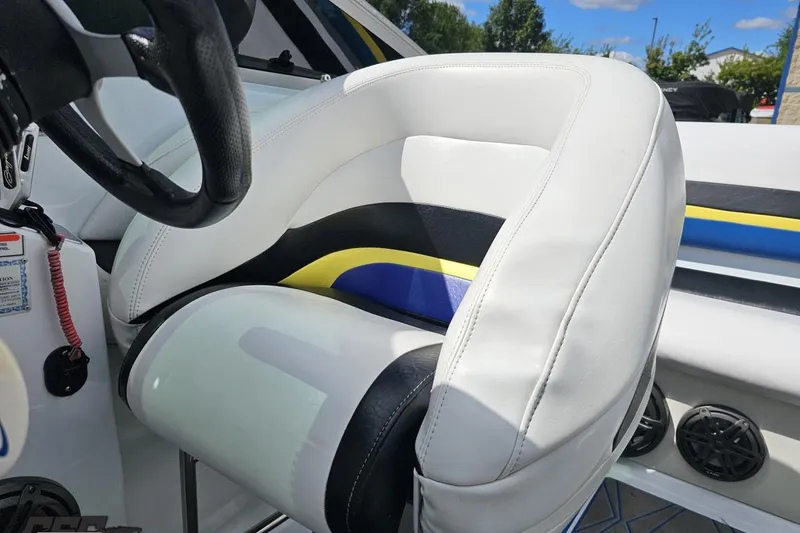 Slide: The Image of 2005 Baja 275 boat interior with white and blue seating, steering wheel, and dashboard. - 87