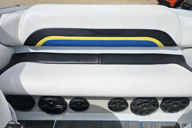 Slide: The Image of 2005 Baja 275 boat interior with white seating and multiple black speakers. - 90