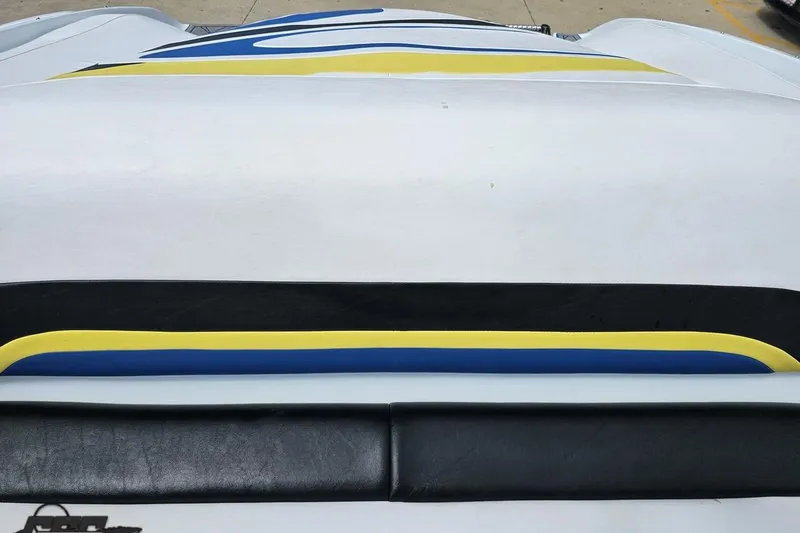 Slide: The Image of 2005 Baja 275 boat with colorful upholstery design in blue, yellow, and black. - 92