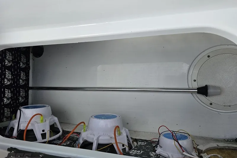 Slide: The Image of 2005 Baja 275 boat interior with audio system components and wiring. - 93
