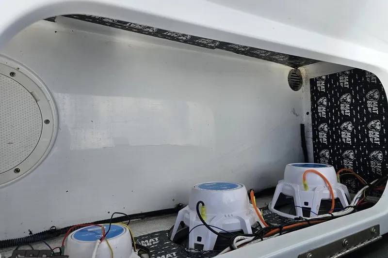 Slide: The Image of Interior of a 2005 Baja 275 boat showing audio system components and wiring. - 95