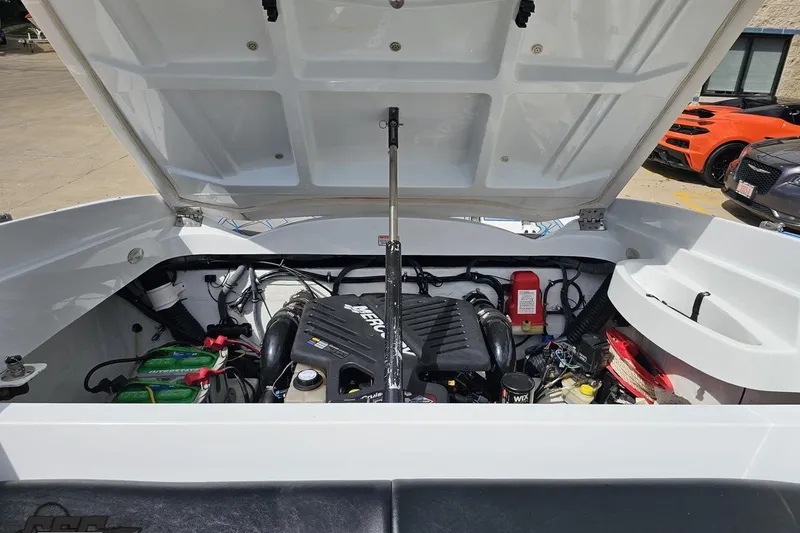 Slide: The Image of Open engine compartment of a 2005 Baja 275 boat, showcasing the engine and components. - 96