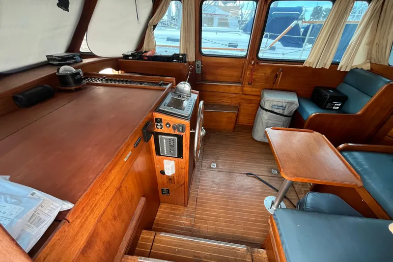 Slide: The Image of Interior of a 1986 Nauticat 33' sailboat with wooden furnishings and navigation equipment. - 23