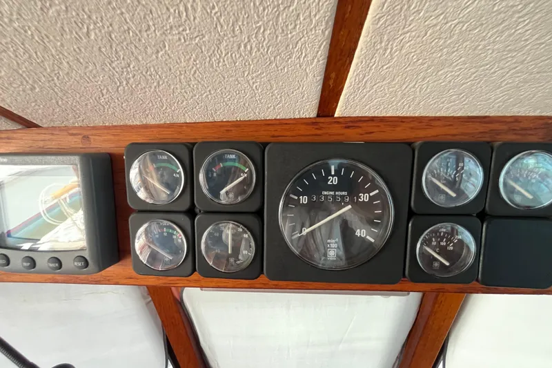 Slide: The Image of Instrument panel of a 1986 Nauticat 33' sailboat, featuring gauges and a digital display. - 27