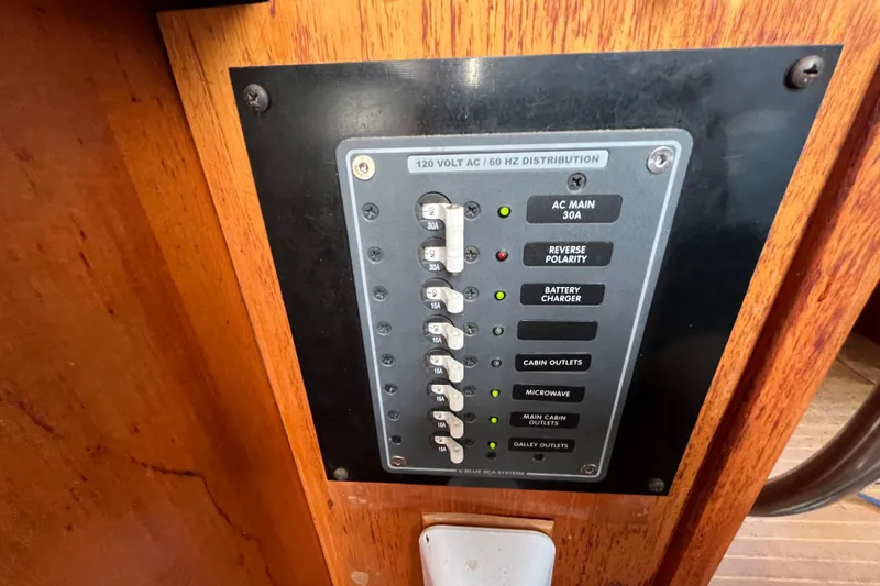 Slide: The Image of Electrical panel on 1986 Nauticat 33' boat, featuring various circuit switches and indicators. - 31