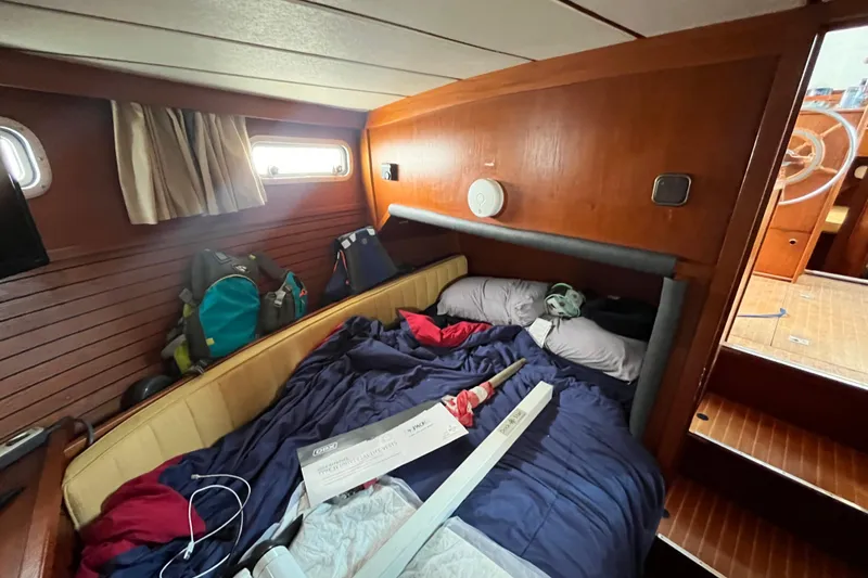 Slide: The Image of Cozy cabin interior of 1986 Nauticat 33' sailboat with bed and gear. - 36