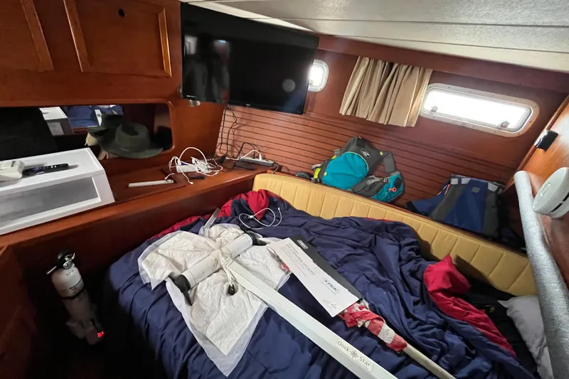 Slide: The Image of Cozy cabin interior of a 1986 Nauticat 33' sailboat with bed and storage. - 37