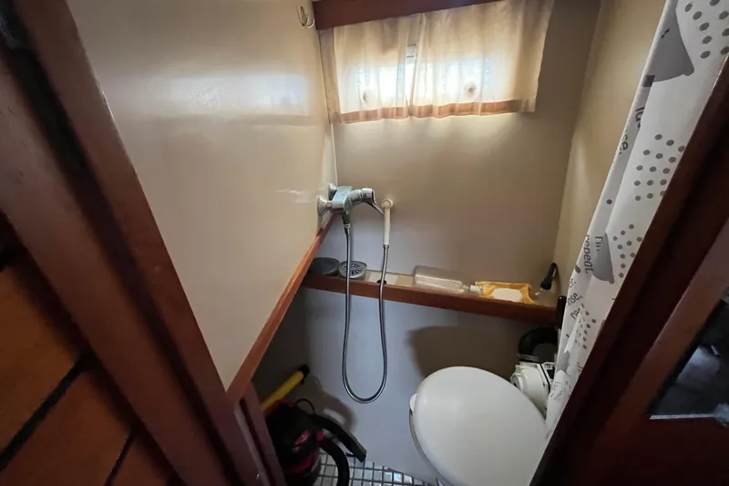 Slide: The Image of Compact bathroom in a 1986 Nauticat 33' sailboat with shower and toilet. - 38