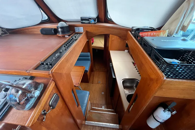 Slide: The Image of Interior of 1986 Nauticat 33' sailboat with wooden finishes and compact kitchen area. - 40