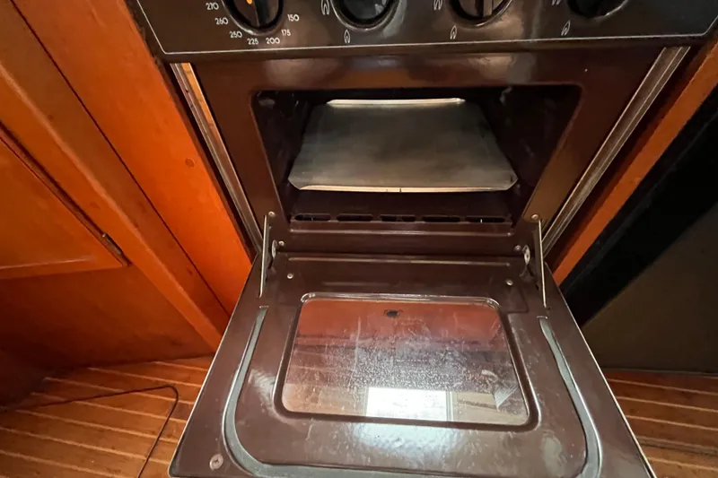 Slide: The Image of Open oven door inside 1986 Nauticat 33' sailboat kitchen. - 45