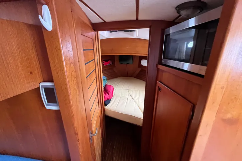 Slide: The Image of Interior of 1986 Nauticat 33' sailboat with cozy cabin and wooden finishes. - 51
