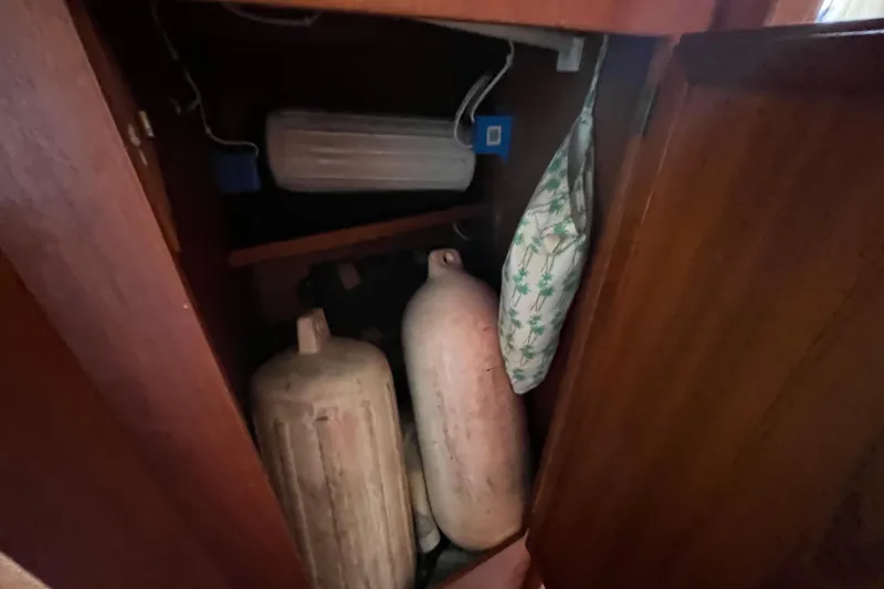 Slide: The Image of Storage compartment in a 1986 Nauticat 33' boat with fenders and equipment. - 57