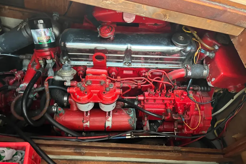 Slide: The Image of Engine of a 1986 Nauticat 33' sailboat, featuring red components and visible wiring. - 58