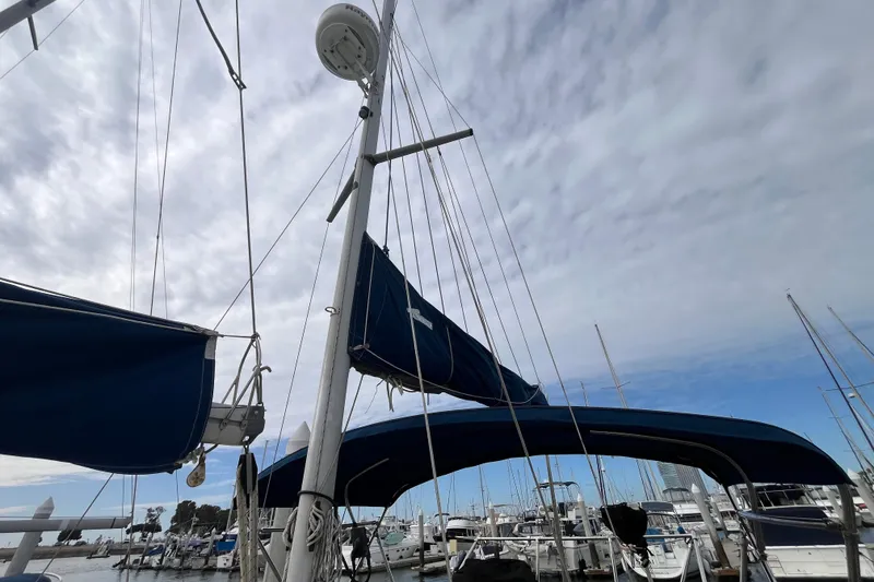 Slide: The Image of Sailboat mast and rigging of 1986 Nauticat 33' under cloudy sky at marina. - 8
