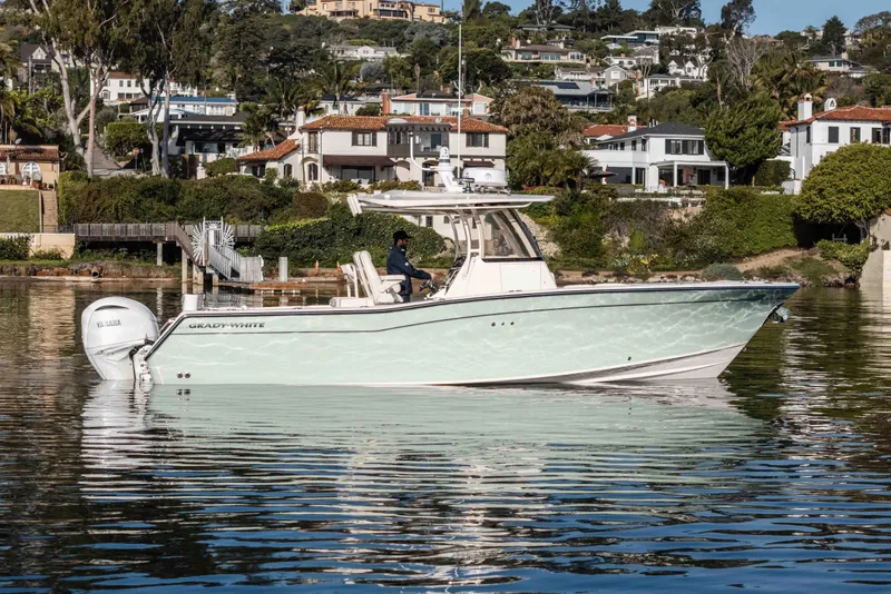 The Image of 2022 Grady-White Canyon 306 boat on calm water near residential area. - 1
