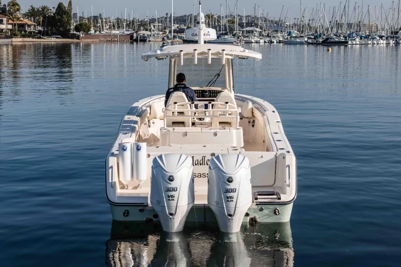 Slide: The Image of 2022 Grady-White Canyon 306 boat with dual engines on calm water. - 12