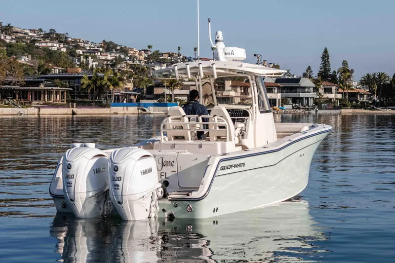 Slide: The Image of 2022 Grady-White Canyon 306 boat with twin Yamaha engines on calm water. - 15