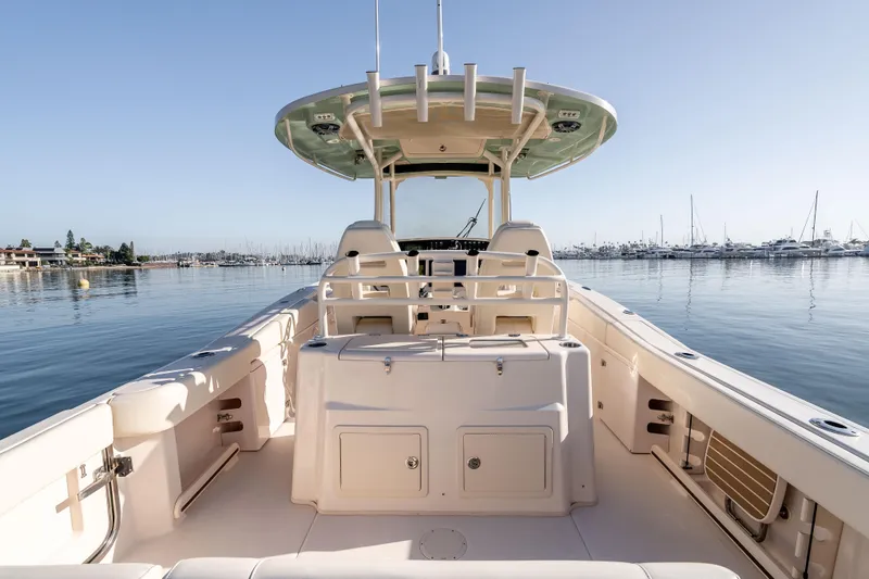 Slide: The Image of 2022 Grady-White Canyon 306 boat on calm water, marina in background. - 18