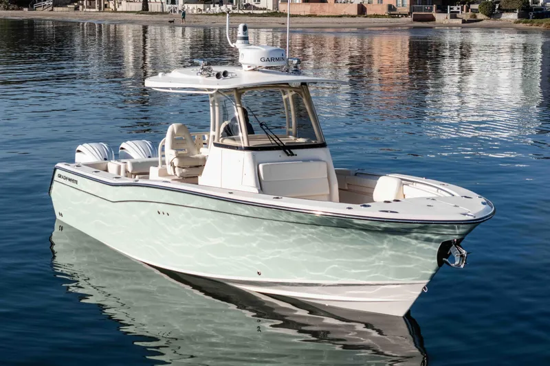 Slide: The Image of 2022 Grady-White Canyon 306 boat on calm water, showcasing sleek design and modern features. - 4