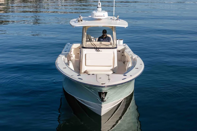 Slide: The Image of 2022 Grady-White Canyon 306 boat on calm water, front view. - 5