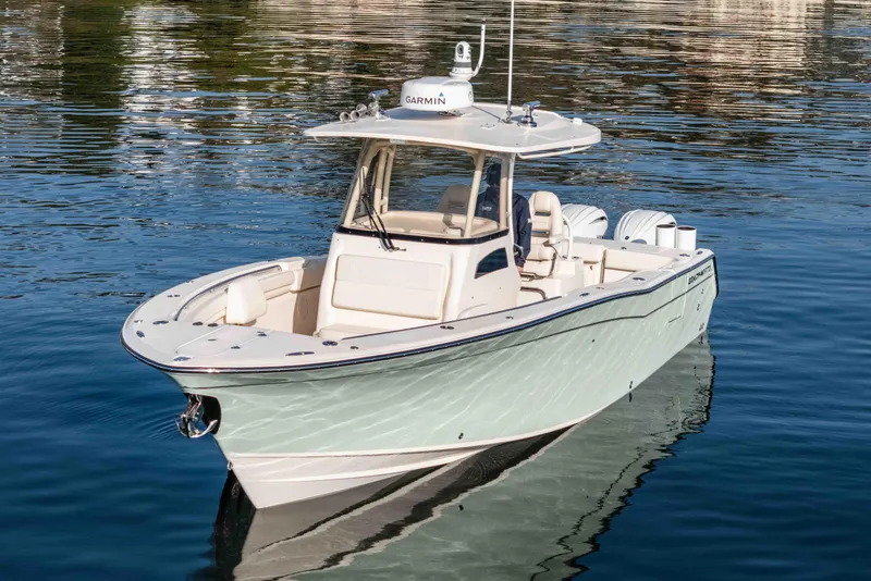 Slide: The Image of 2022 Grady-White Canyon 306 boat on calm water, featuring sleek design and modern equipment. - 7