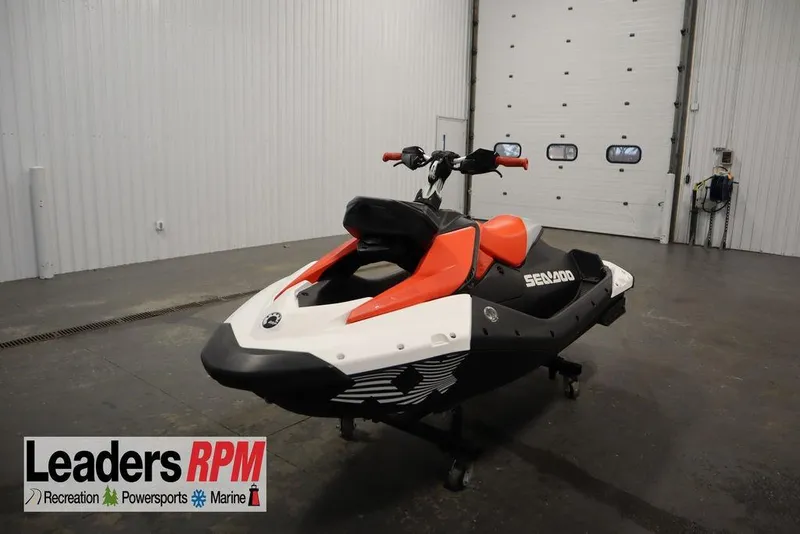 The Image of 2025 Sea-Doo Spark Trixx for 1 in a showroom, featuring vibrant red and white design. - 0