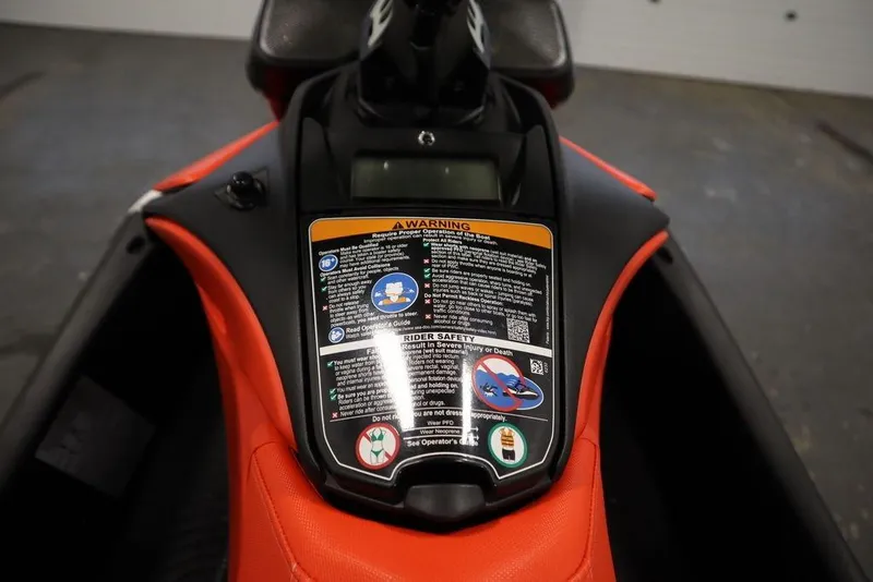 Slide: The Image of 2025 Sea-Doo Spark Trixx dashboard with safety instructions and warning labels. - 12