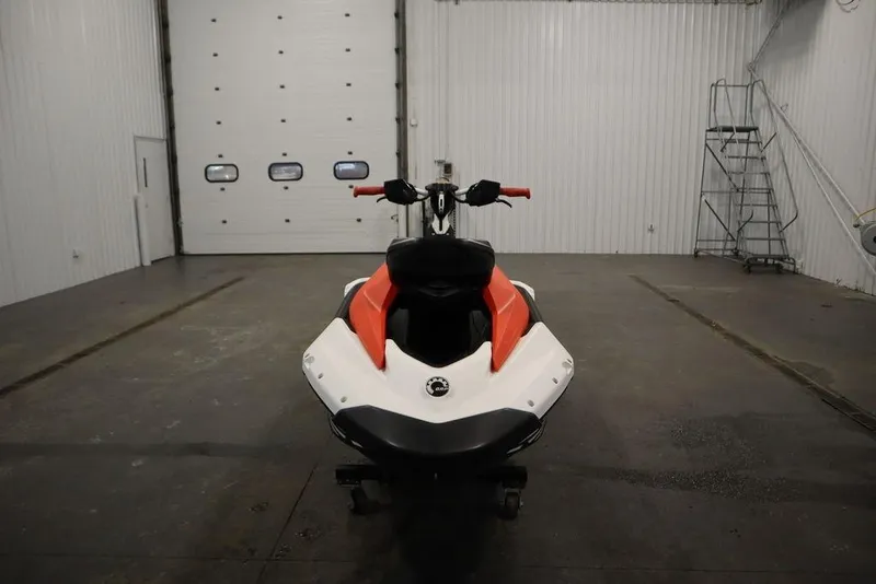 Slide: The Image of 2025 Sea-Doo Spark Trixx for 1 in a garage, front view. - 2