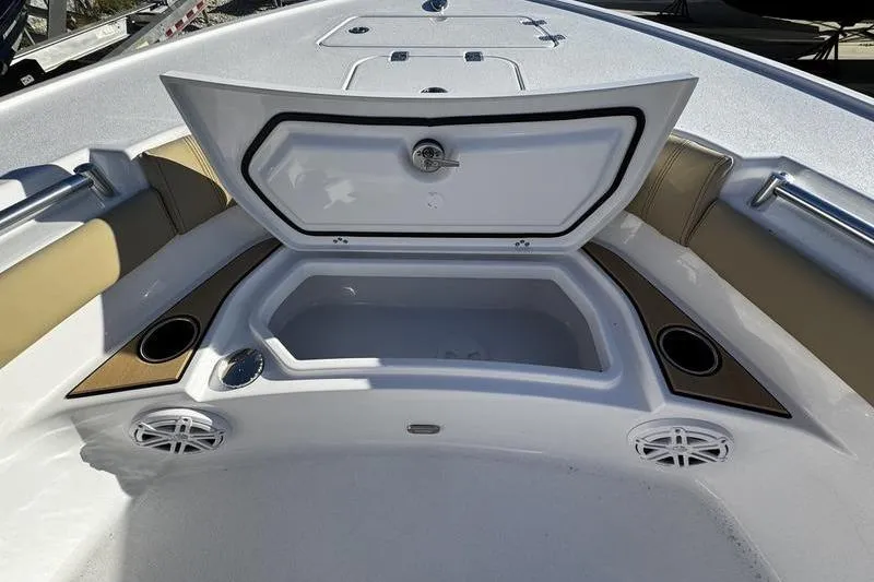 Slide: The Image of 2026 Sportsman Masters 247OE Bay Boat interior with open storage compartment and cup holders. - 10