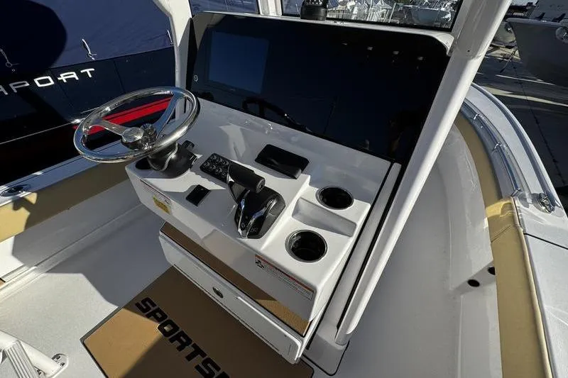 Slide: The Image of 2026 Sportsman Masters 247OE Bay Boat helm with steering wheel and control panel. - 11