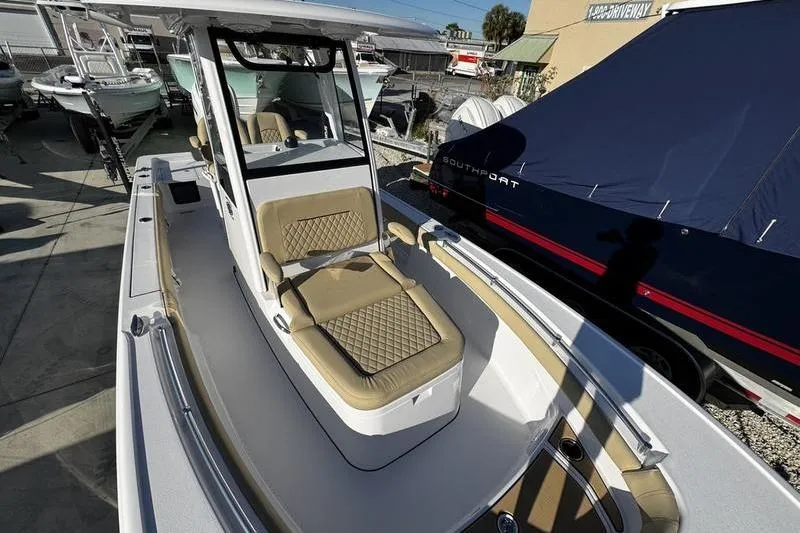Slide: The Image of 2026 Sportsman Masters 247OE Bay Boat with tan seating, docked outdoors. - 14
