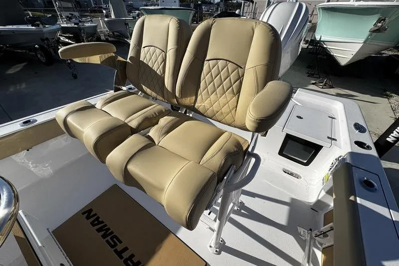 Slide: The Image of Luxurious seating on 2026 Sportsman Masters 247OE Bay Boat, featuring tan upholstery and armrests. - 16